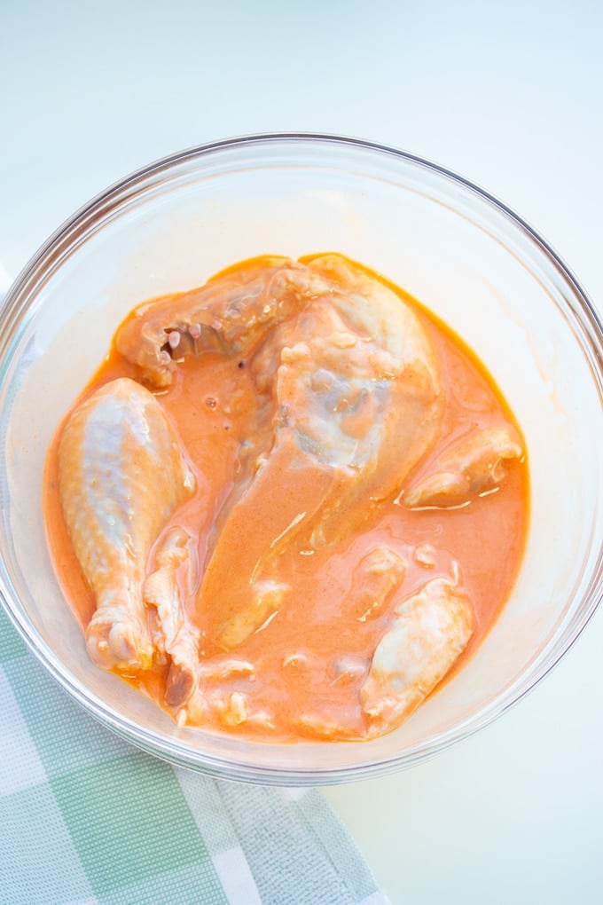 chicken pieces in buttermilk and hot sauce