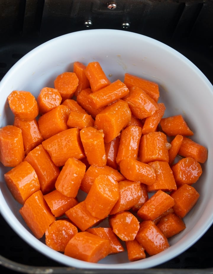 chopped carrots in bowl in air fryer basket