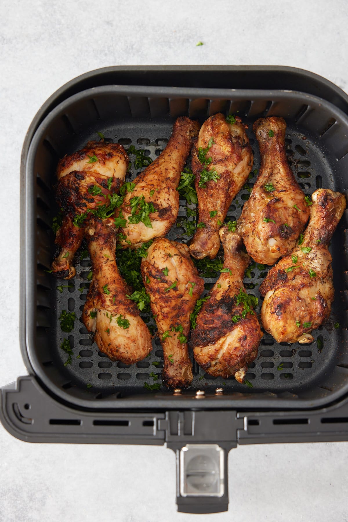 air fryed chicken drumsticks garnished with parsely