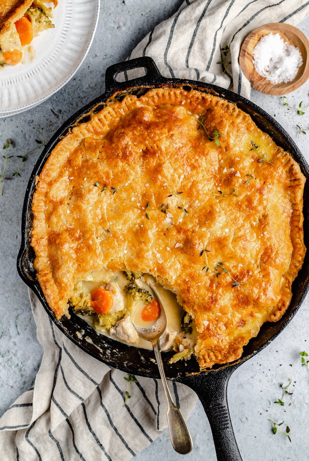 homemade cheddar broccoli leftover turkey pot pie in a skillet with a spoon