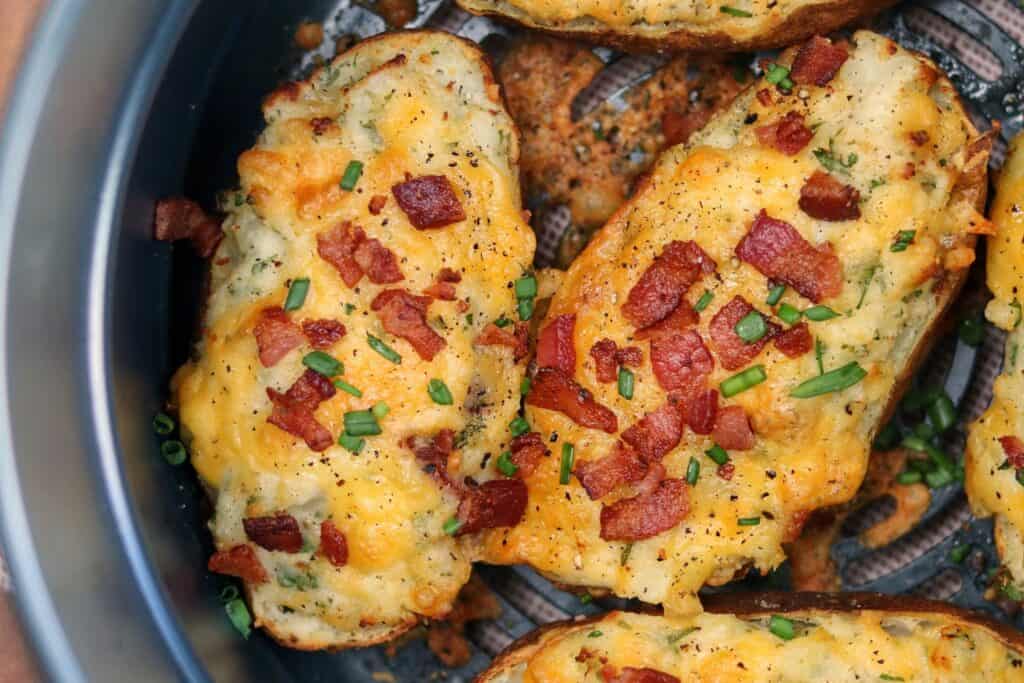 finished twice baked potatoes in the air fryer with chopped bacon and chives