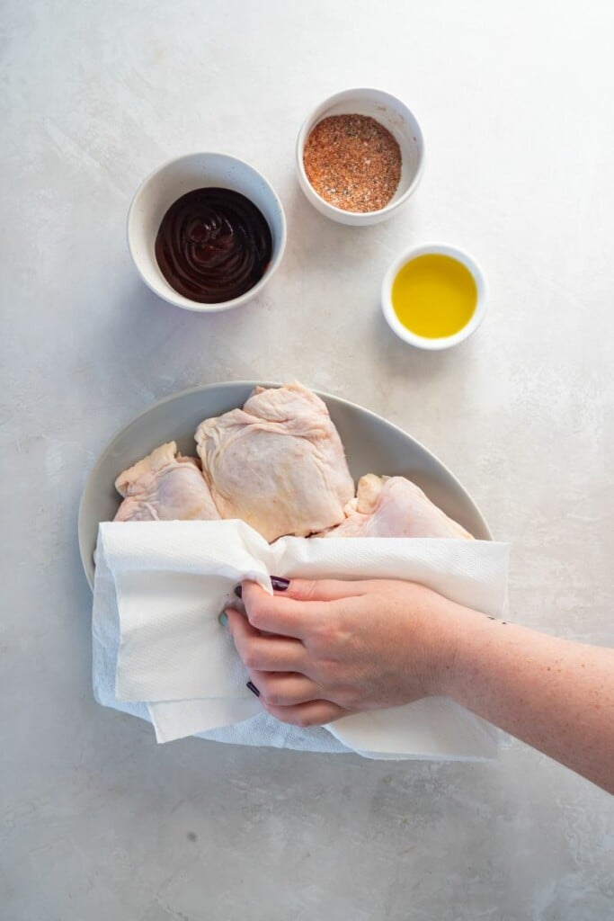 blotting raw chicken thighs