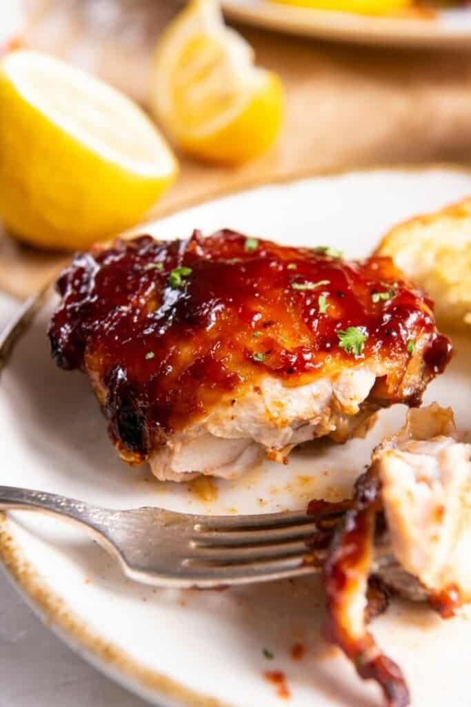 cutting chicken thigh with fork