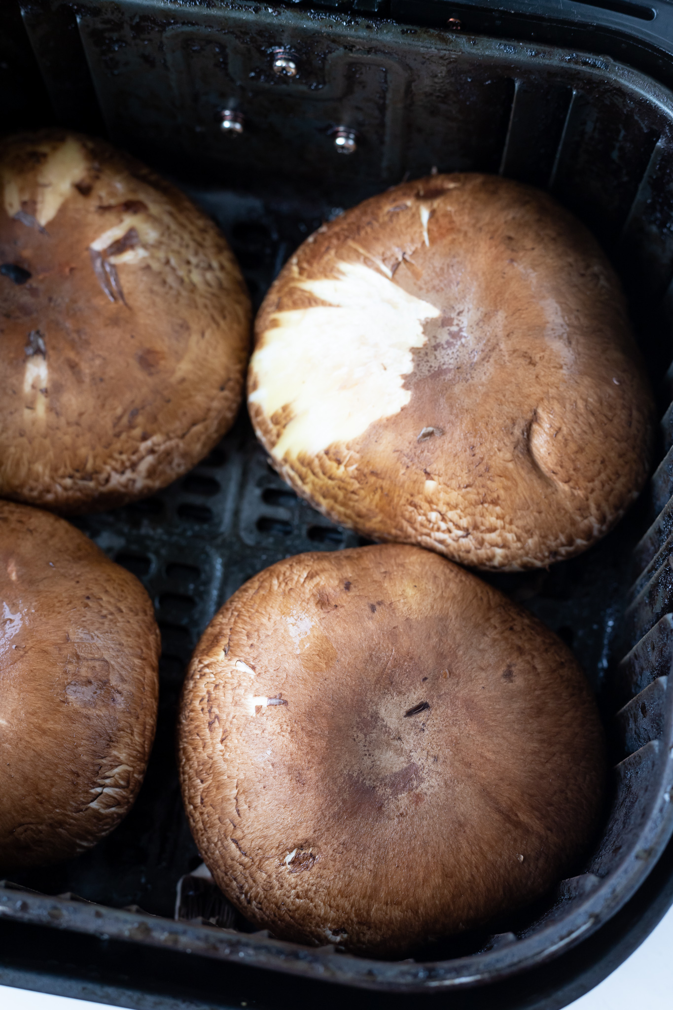 raw mushrooms in air fryer basket