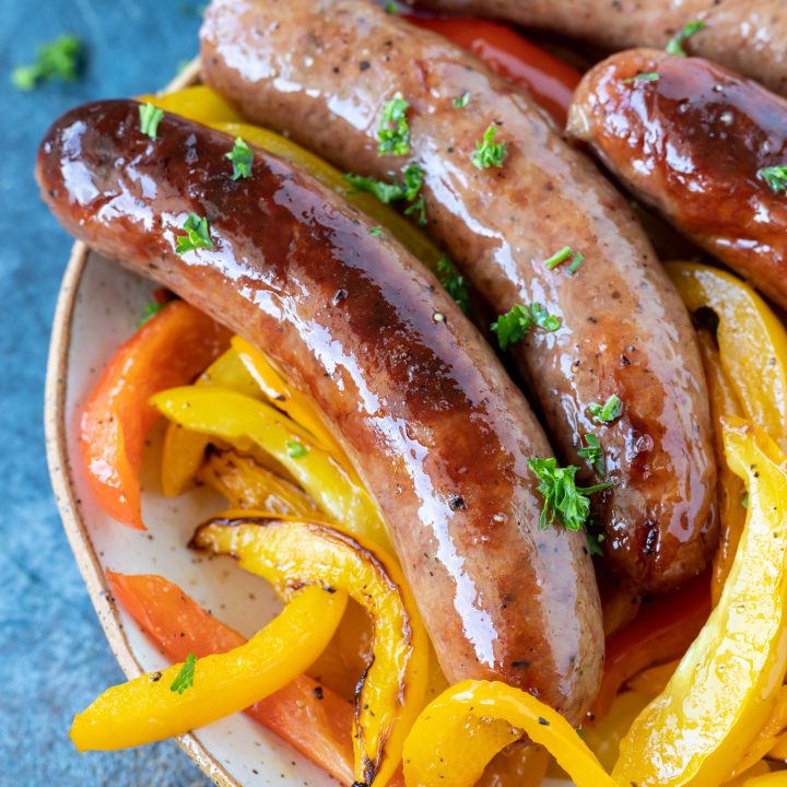 brats and peppers in white dish