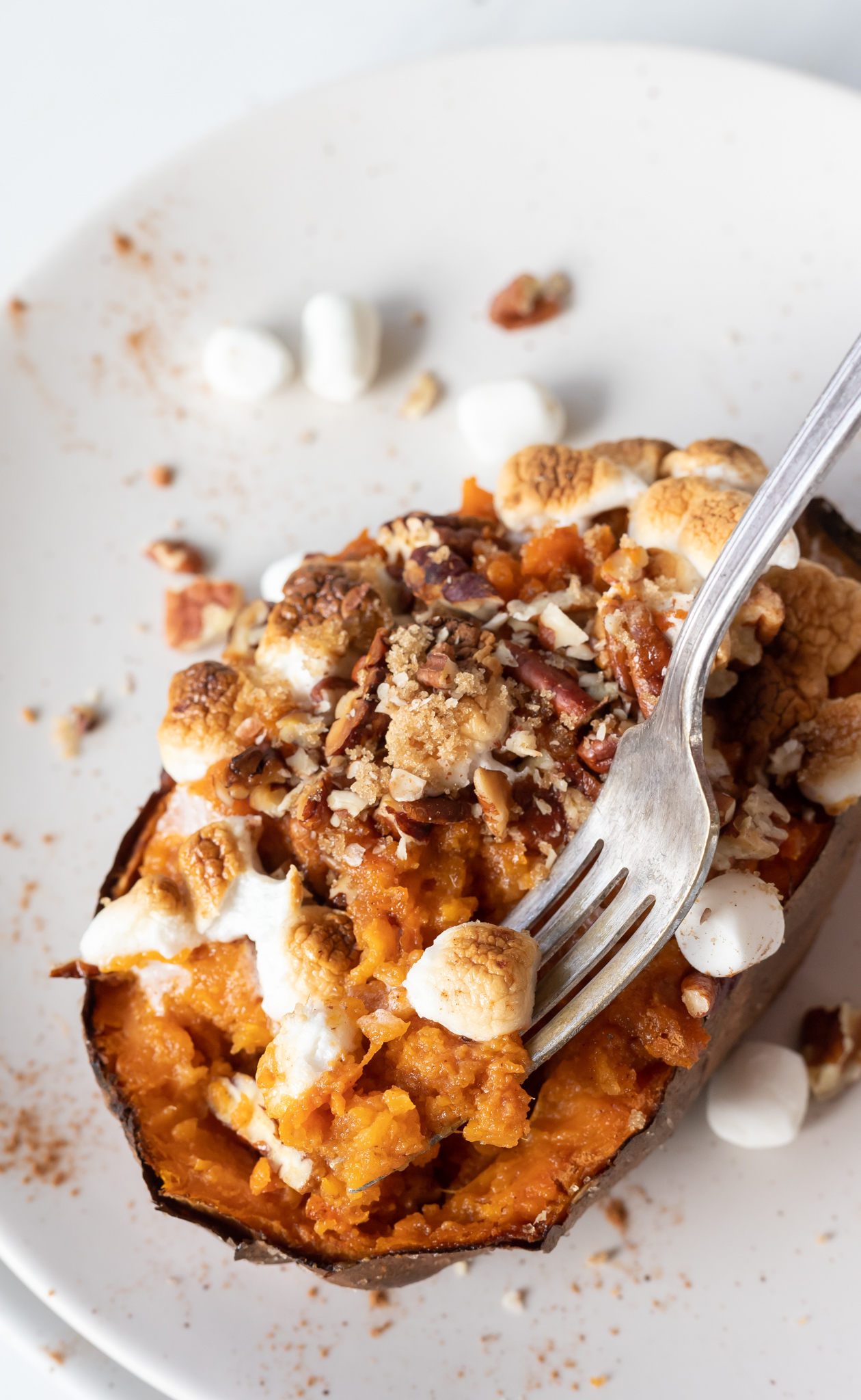 fork scooping a bite from sweet potato