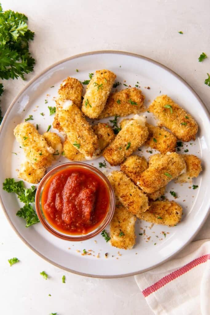 overhead shot of mozzarella sticks on a plate