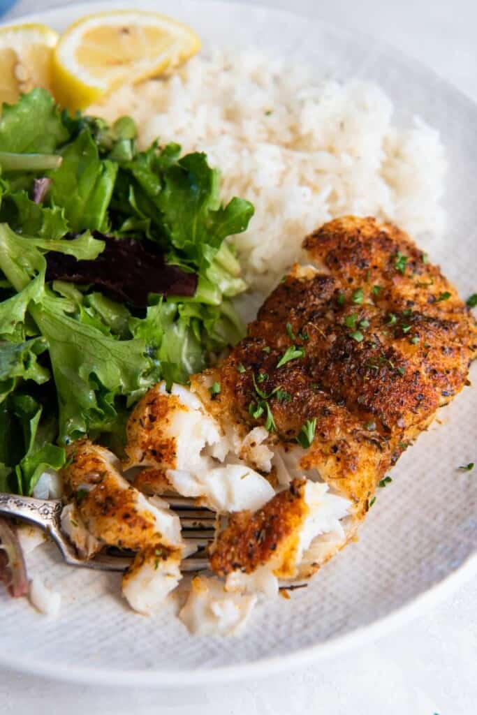 fork digging into a piece of haddock