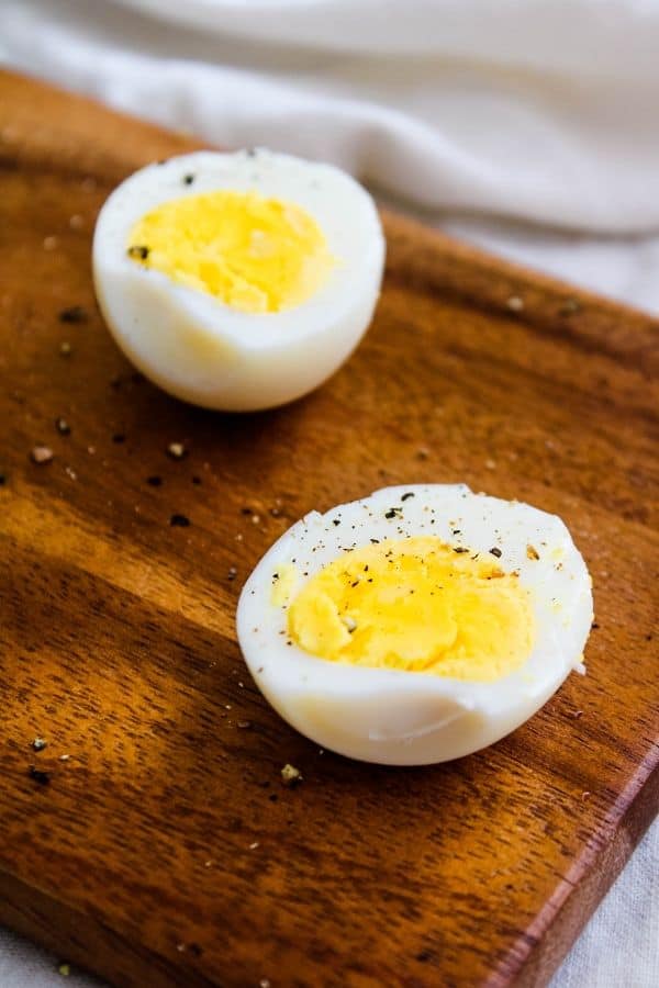 Hard Boiled Eggs Peeled and Halved on cutting board