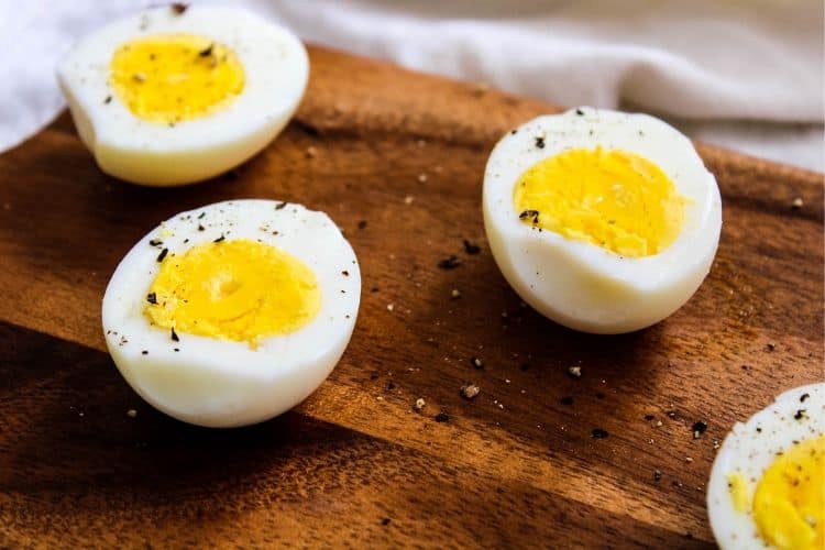 Air Fryer Hard-Boiled Eggs halved on a cutting board