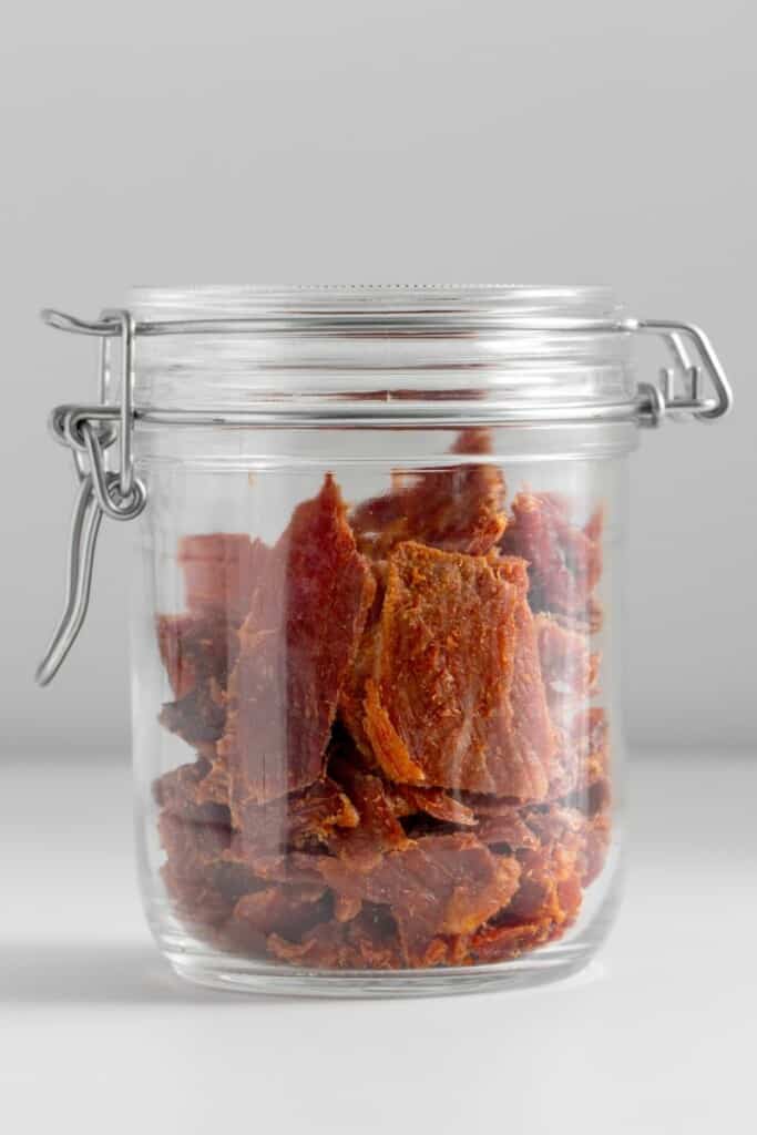 a jar with beef jerky inside