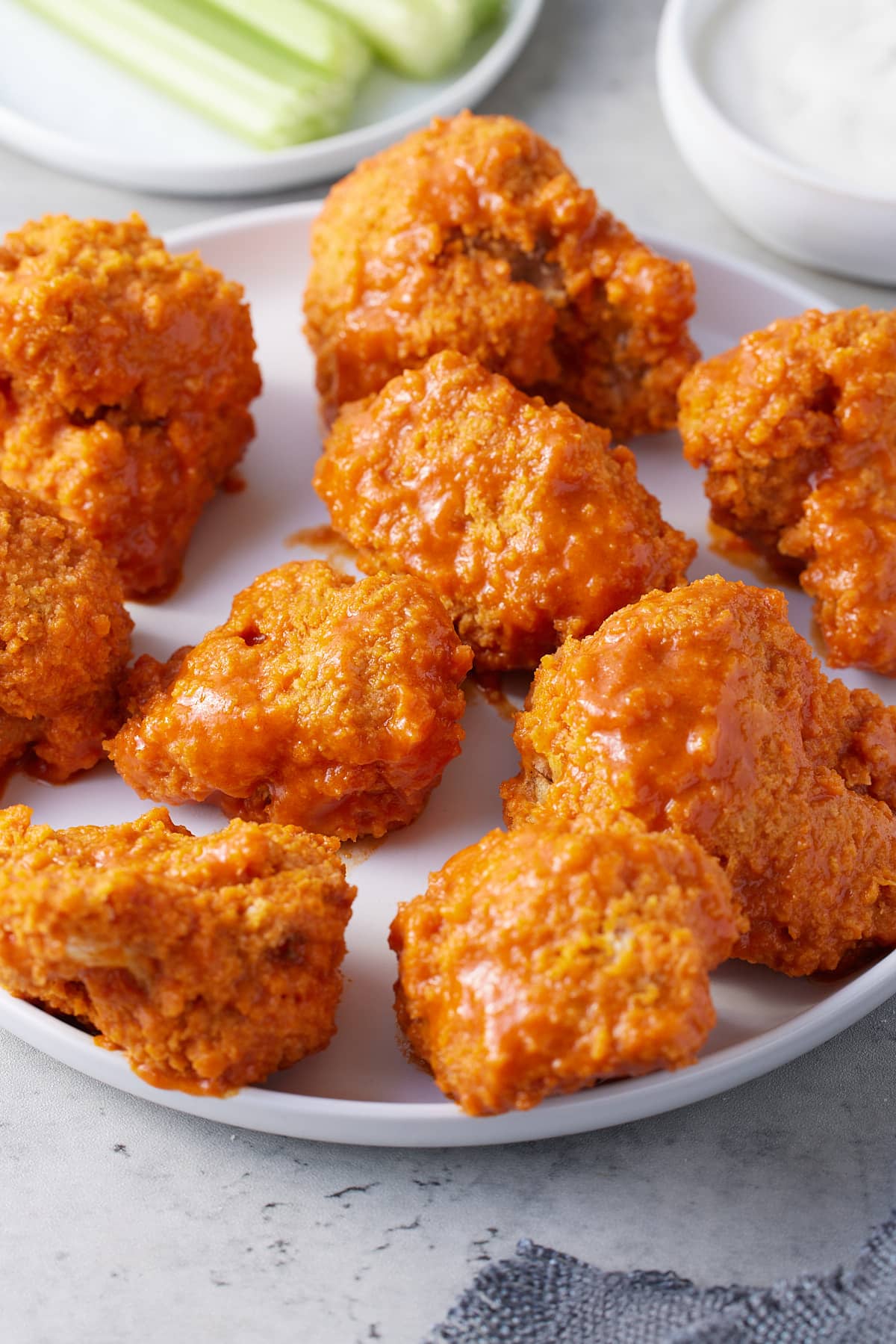 crispy breaded air fryer cauliflower wings coated in wing sauce