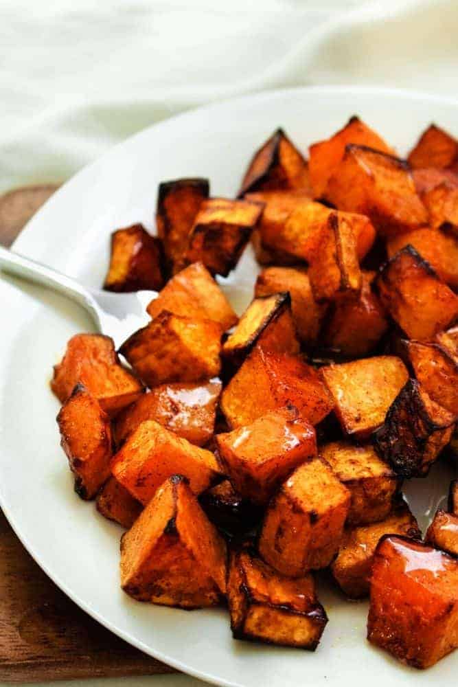 Air Fryer Butternut Squash on a white plate with fork in it