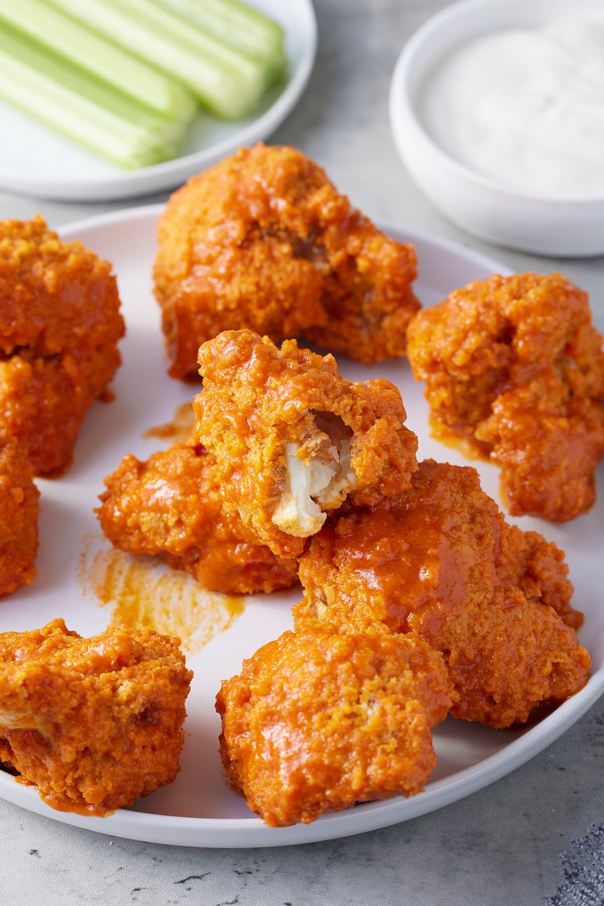 crispy breaded air fryer cauliflower wings coated in wing sauce