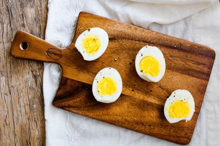 Hard-Boiled Air Fried Eggs on a small wooden cutting board