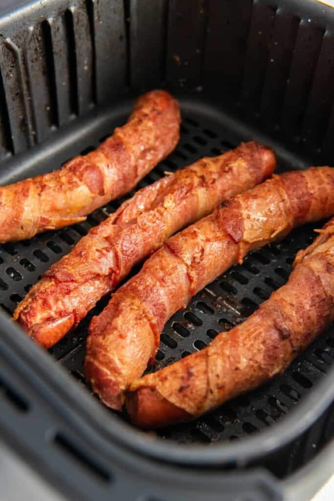 closeup of bacon wrapped hot dogs