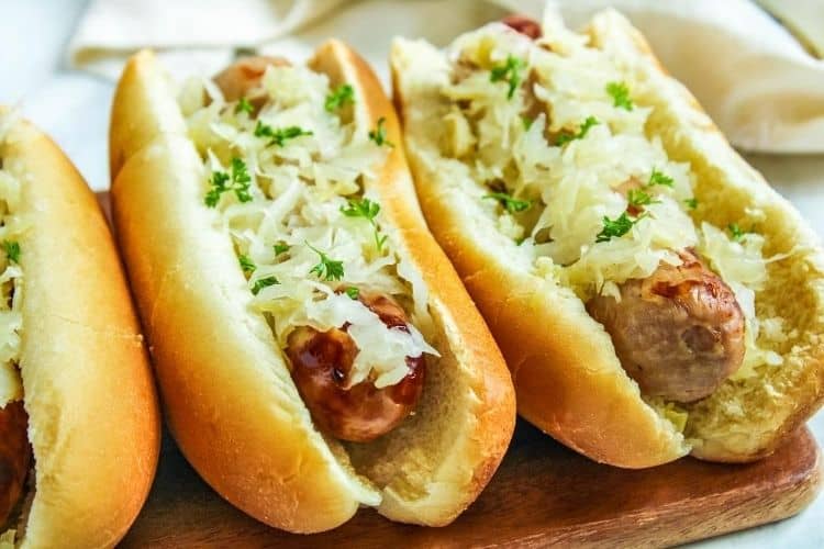 Air Fryer Brats with sauerkraut on top inside buns