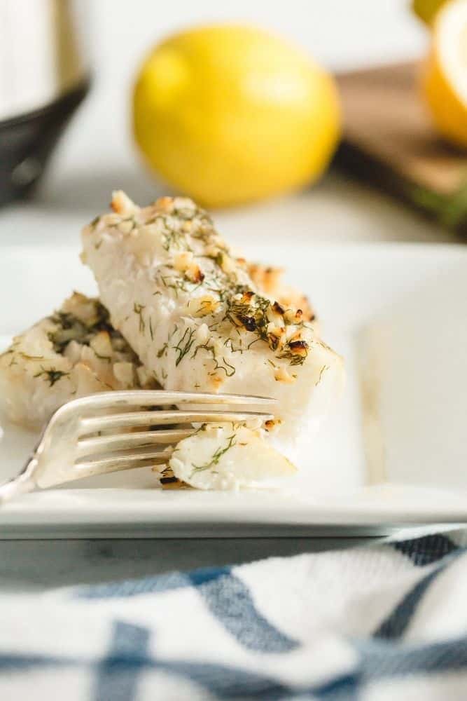 Air Fried Cod on a white plate with a fork cutting a slice