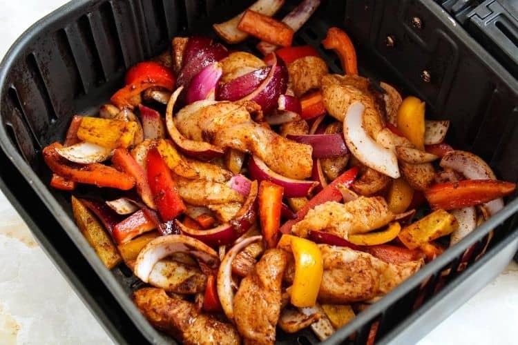 Raw chicken fajitas inside air fryer