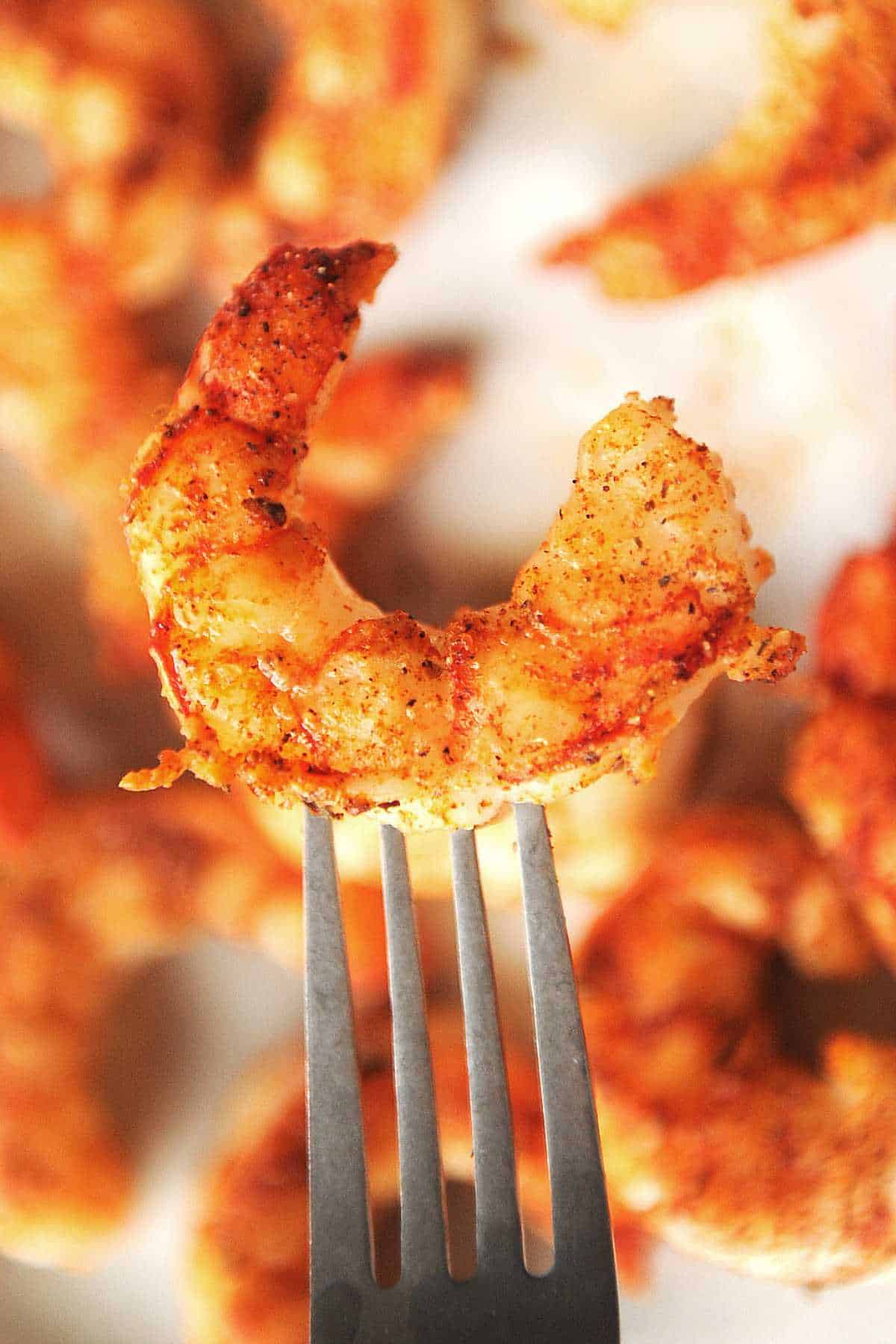 close up shot of air fryer argentine red shrimp on a fork.