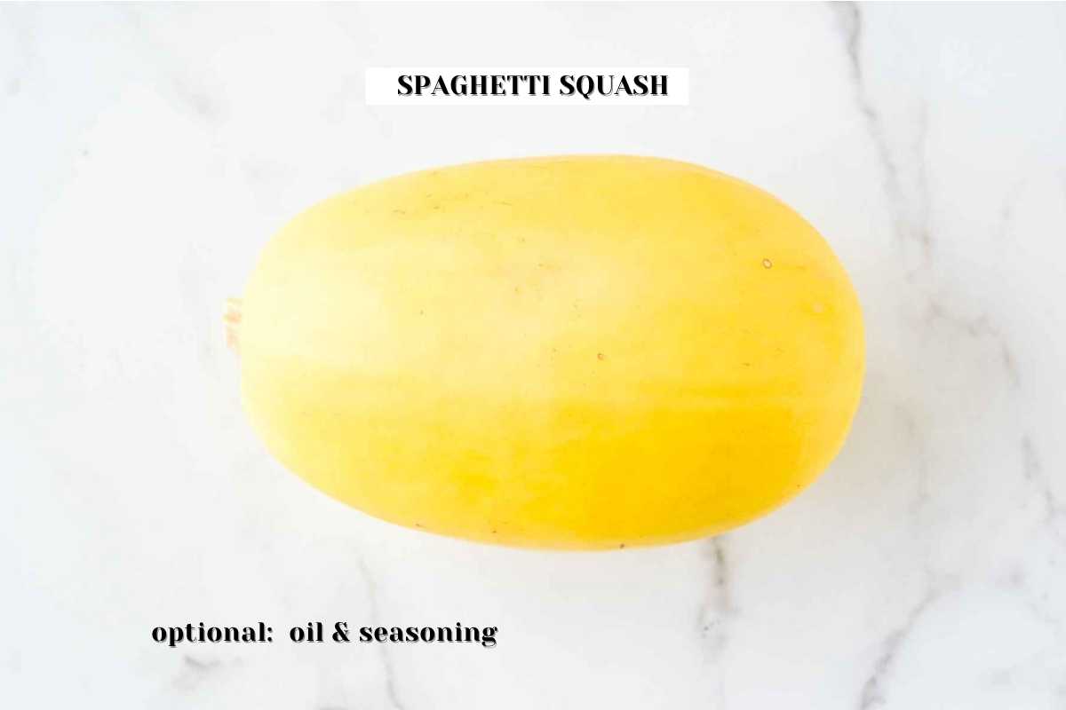 the ingredients for this recipe air fryer spaghetti squash on a white marble background.